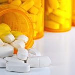 Prescription Medication Spilling From an Open Medicine Bottle