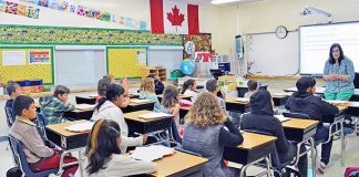 Excited students and staff answer the school bell