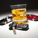 Highway Patrol Police and Sports Car Next to Alcoholic Drink and Keys Under Spot Light.