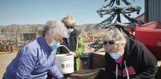Volunteers prepare flower planters