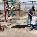Volunteers install new playground