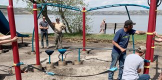 Volunteers install new playground