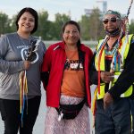 Two Indigenous women holding walks of sorrow