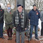 100-year old veteran stands to remember