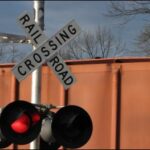 Train derails after colliding with road maintenance truck; one man dead