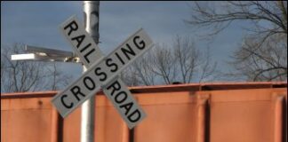 Train derails after colliding with road maintenance truck; one man dead