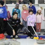 Walker/Muyres teach young curlers at clinic