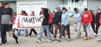Students walk for missing women at Red Dress Day